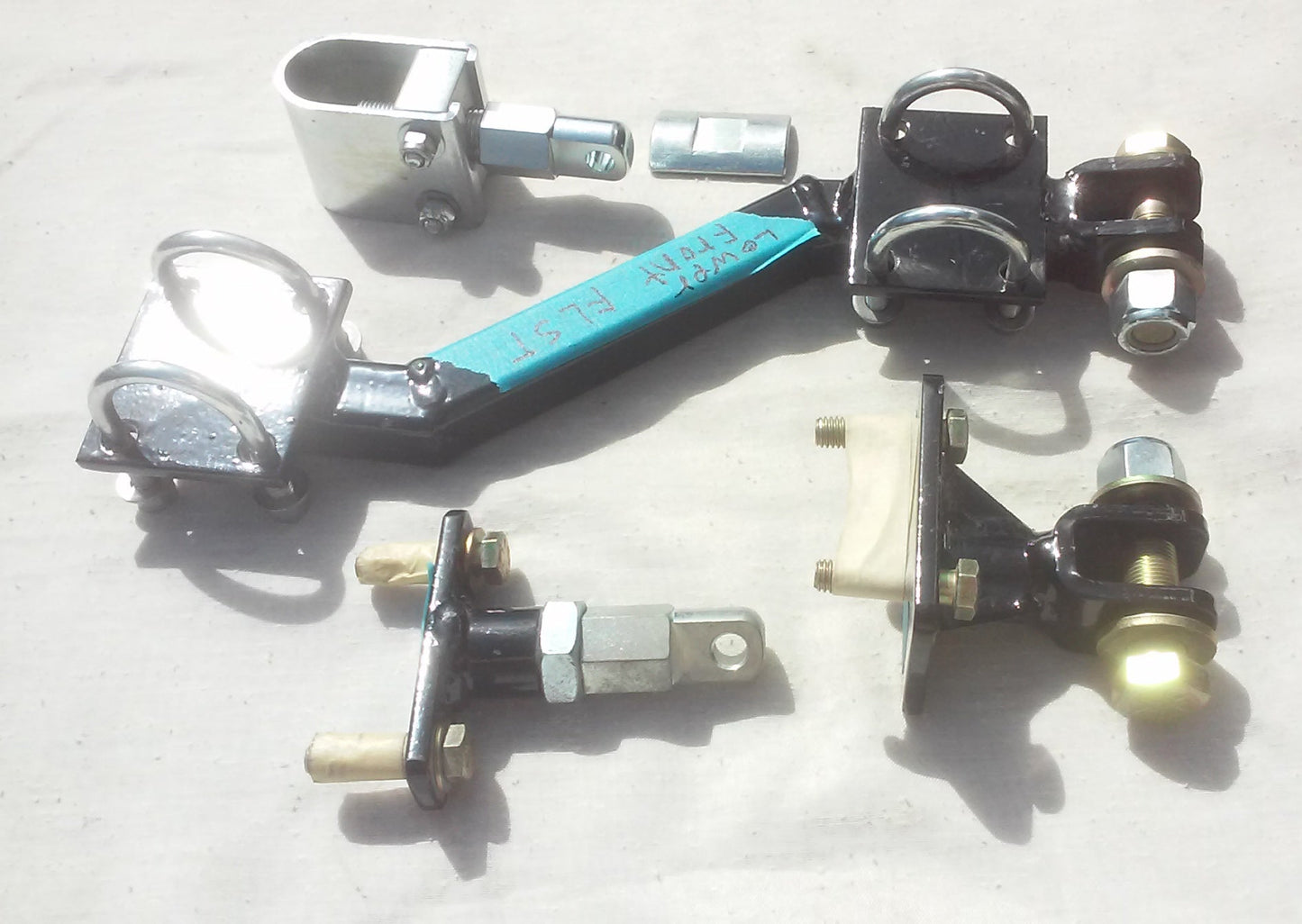 Collection of sidecar mounts of metal components on a light gray surface